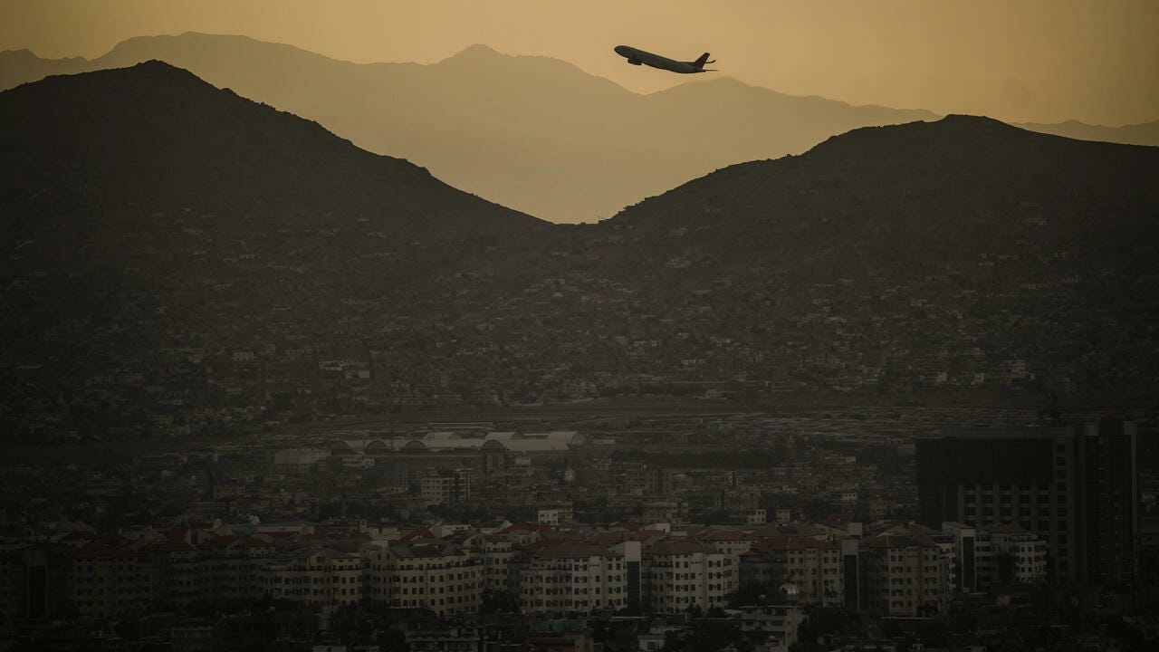 A plane flying over a city

Description automatically generated with medium confidence