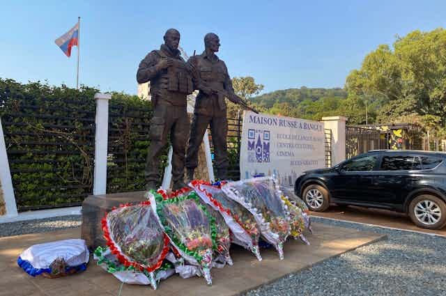 Wreaths laid at the foot of a statue Wreaths laid at the foot of a statue