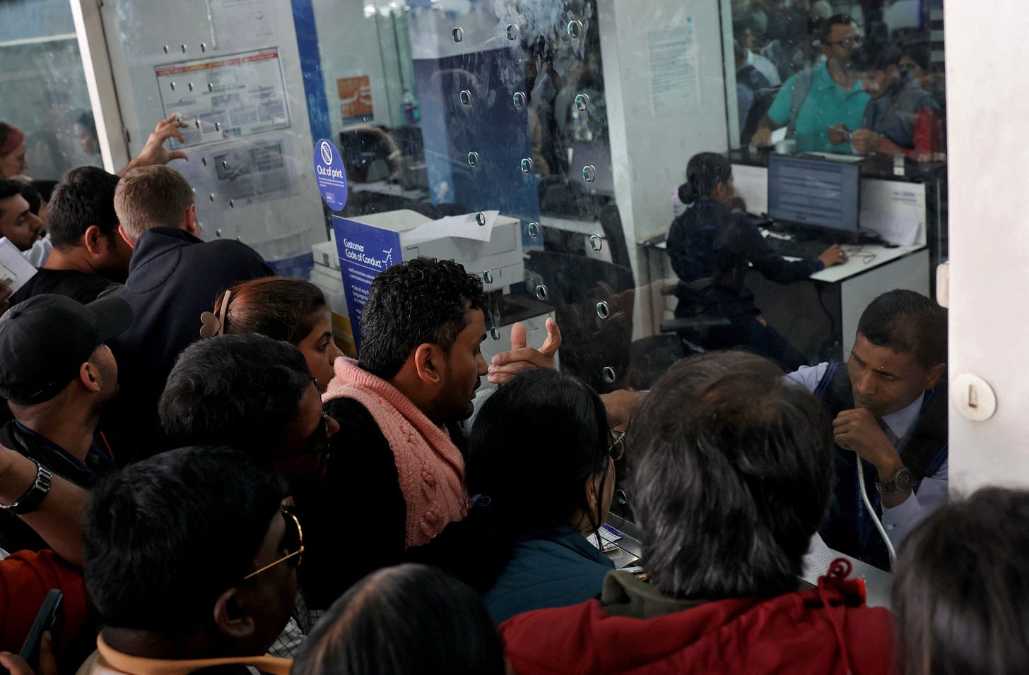 Travellers enquire about their flights at IndiGo kiosks at the Kempegowda international airport in Bengaluru