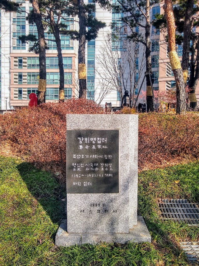 A stone monument in front of a building

AI-generated content may be incorrect.