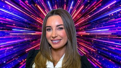 A woman with long hair smiles to camera, set against a sparkling backdrop with beams of blue, pink and purple light A woman with long hair smiles to camera, set against a sparkling backdrop with beams of blue, pink and purple light