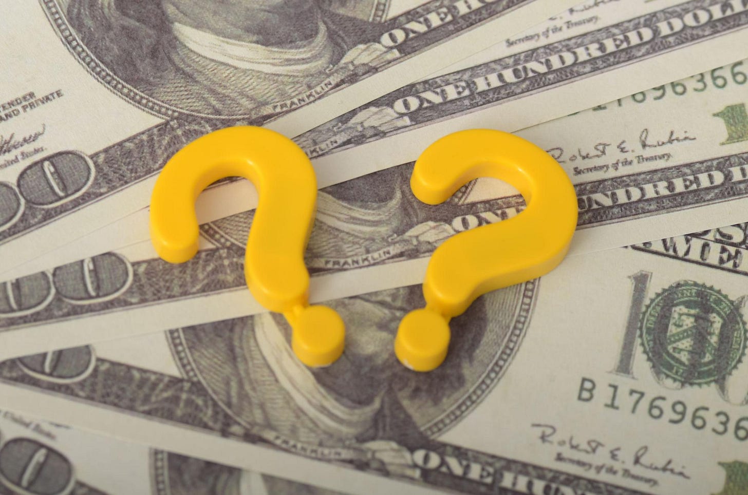 Understanding Financial Uncertainty: Question Mark and USD Money Background Symbolizing Economic Decisions