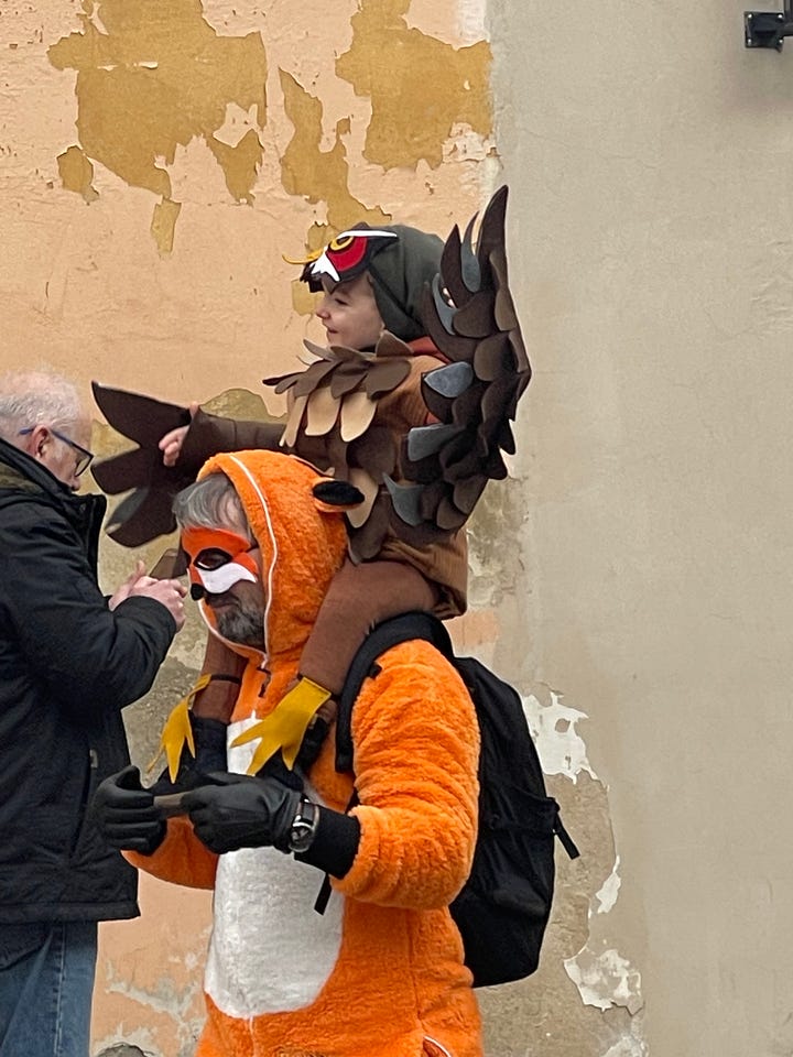 A woman offers cups of svařák (Czech mulled wine) to strangers during the Masopust procession.