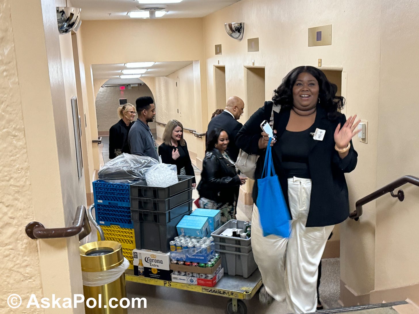 A janitor and his large pushcart of beers and sodas waits for an elevator as a Congressman boards one and a group of tourists walk past Photo: Matt Laslo 