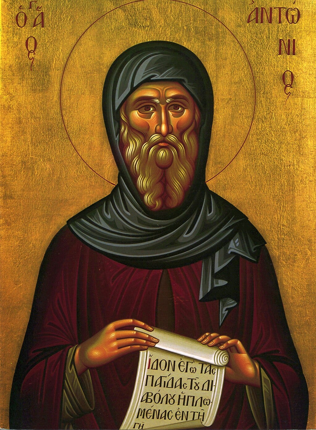 Icon of Saint Anthony, who is wrapped in blue and red robes on a golden background