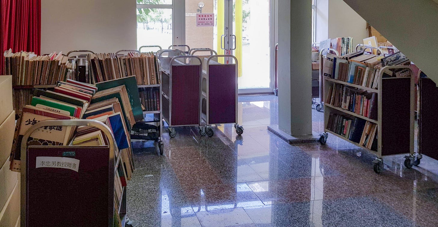 Library carts stacked full of books are parked near an emergency exit in the Donghwa University Library in Hualien, Taiwan
