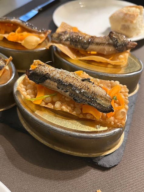 Soy marinated anchovies on a fried cracker, thinly sliced cured duck, miso scallops on the shell