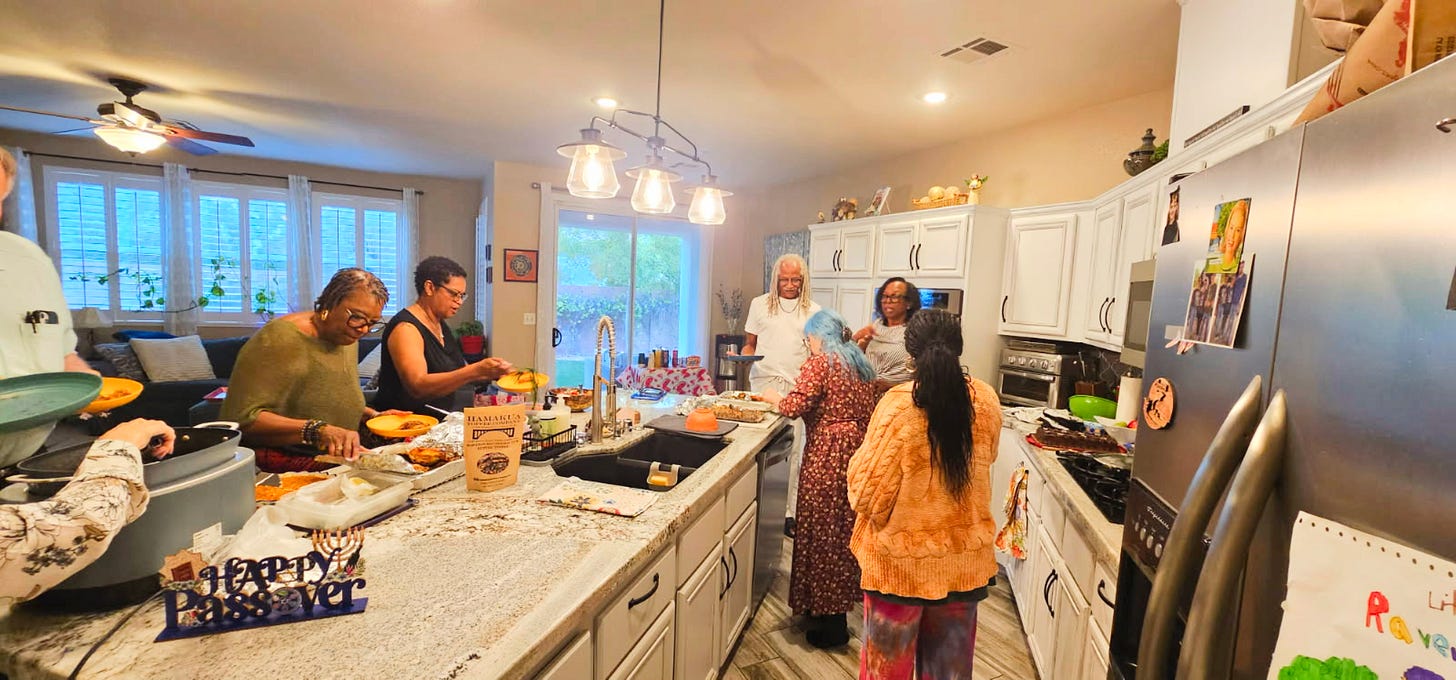 A friend group gathered in a home kitchen preparing dishes for a Passover Seder, representing community collaboration, shared cooking, and cultural storytelling through food.