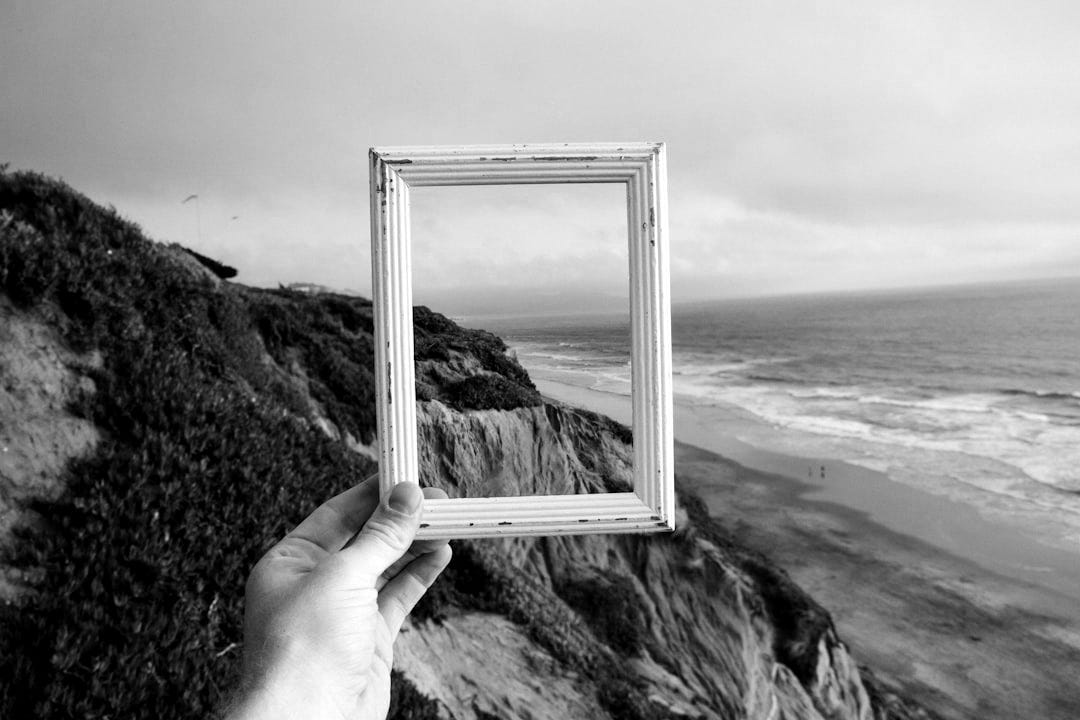 person hand holding photo frame