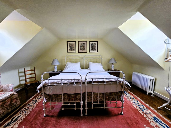 Bedroom shots, showing high four poster beds with Oriental rugs on the floor.