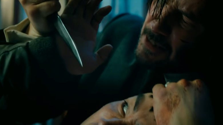 close up of John Wick preparing to stab someone in the eye