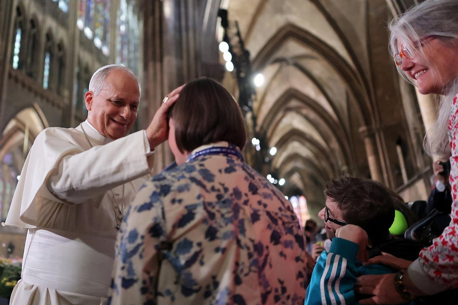 Pope Leo XIV places his hand on a woman’s head to bless her inside Metz Cathedral Pope Leo XIV places his hand on a woman’s head to bless her inside Metz Cathedral