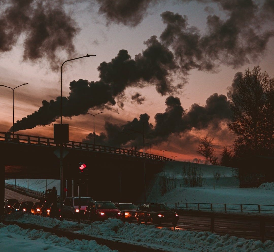 cars on road under cloudy sky during night time