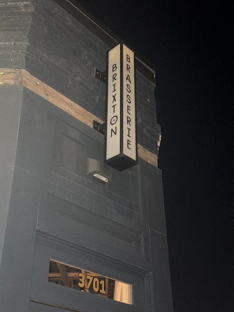 1. sign outside the restaurant reads "brasserie brixton", 2. a close up of the menu, fork, napkin, and water glass on the table, 3. a photo taken from above the table setting