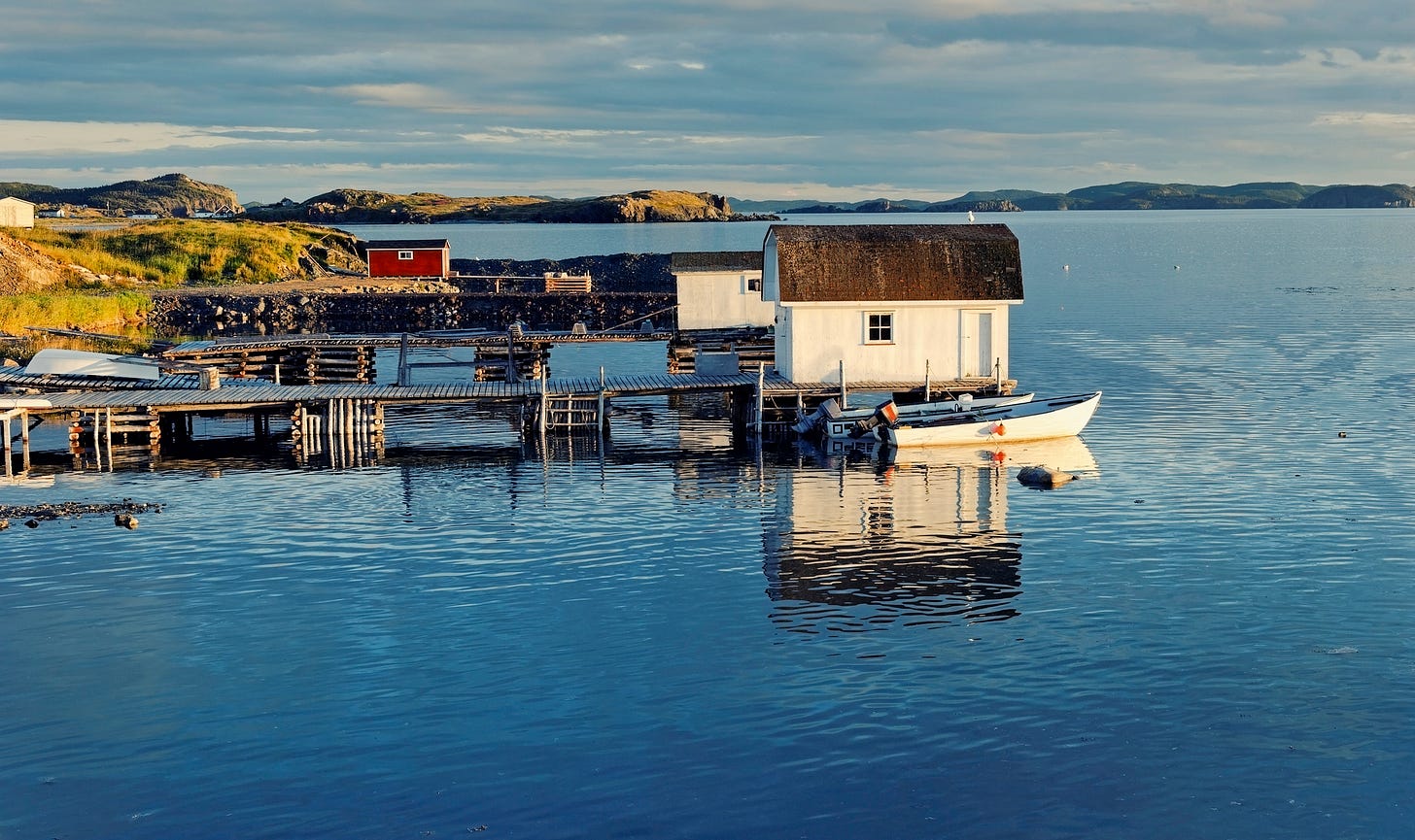 Just one runabout with an outboard motor is visible in photo of two ramps and boathouses