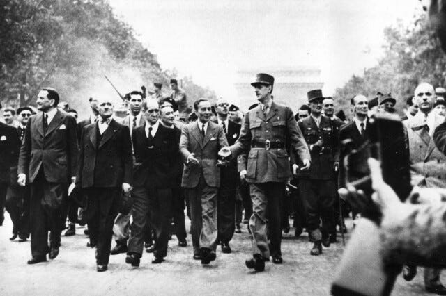 General Charles de Gaulle, wearing a hat, leads a triumphant victory parade down the Champs-Élysées in Paris, celebrating the Allied liberation of the city from German forces during World War II. He confers with General Jacques Leclerc during the historic march.