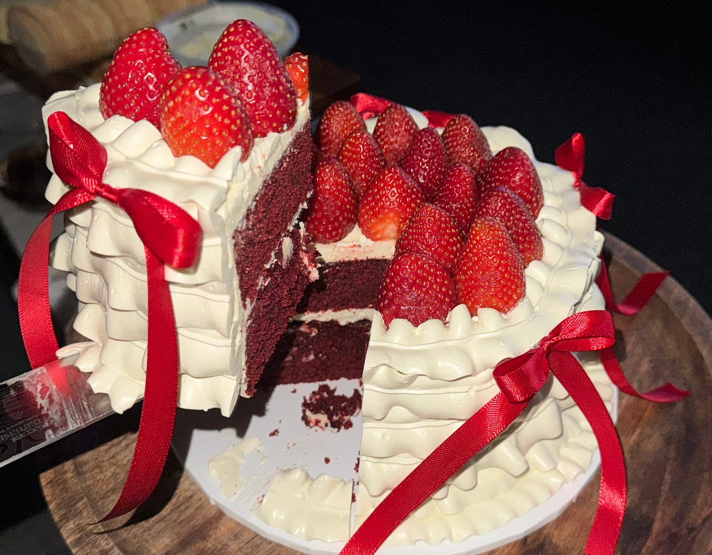 Red Velvet Cake with Strawberries on top and Ribbons on the side