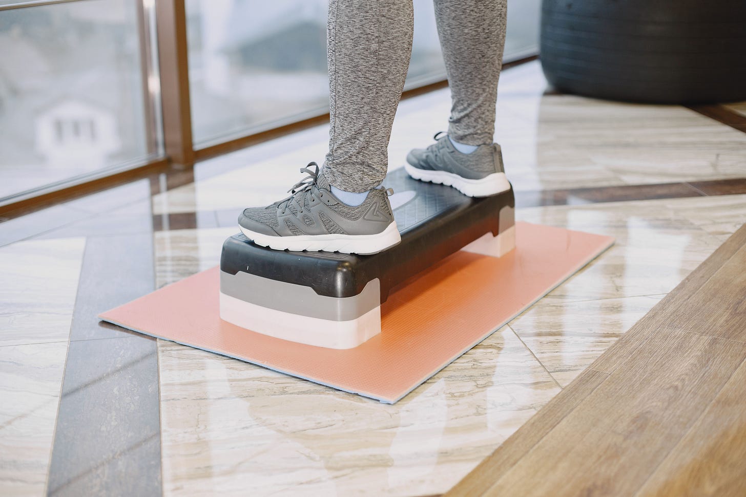 Image of feet on a gym step, in a class.