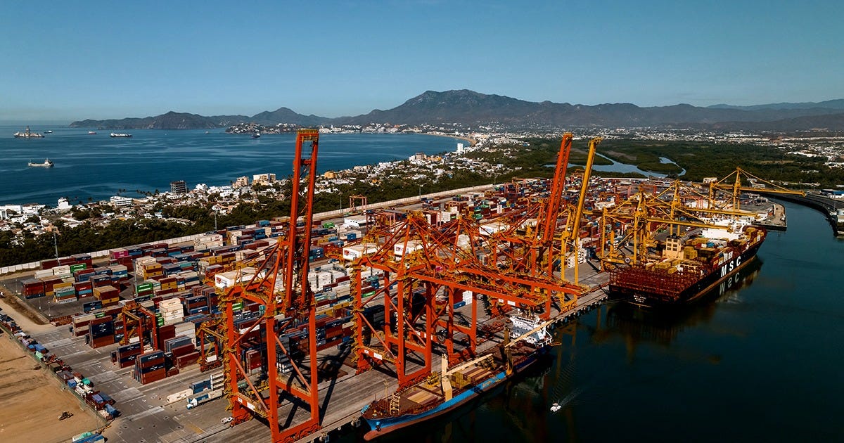 Aerial view of the Port of Manzanillo with colorful shipping containers, cargo ships, and container cranes along the Pacific coast. Aerial view of the Port of Manzanillo with colorful shipping containers, cargo ships, and container cranes along the Pacific coast.