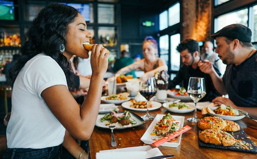 woman in white shirt eating woman in white shirt eating