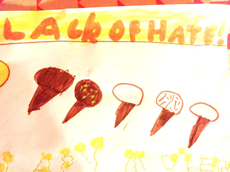A child's drawing of what appear to be mushrooms but are actually ice creams. Written in large writing, carefully coloured in along the top: LACK OF HATE