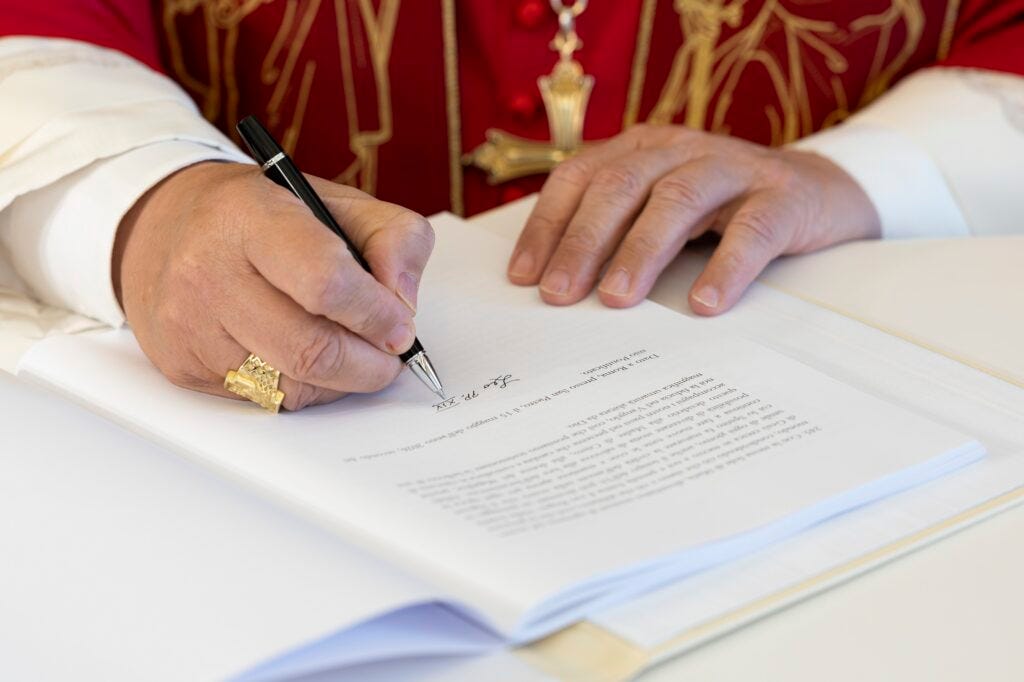 Pope Leo XIV signs "Magnifica Humanitas" at the Vatican's Synod Hall May 15, 2026. The first encyclical of his papacy, officially released May 25, focuses on the rise of artificial intelligence.