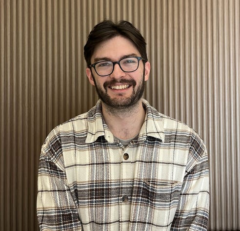 A person smiling at camera

Description automatically generated