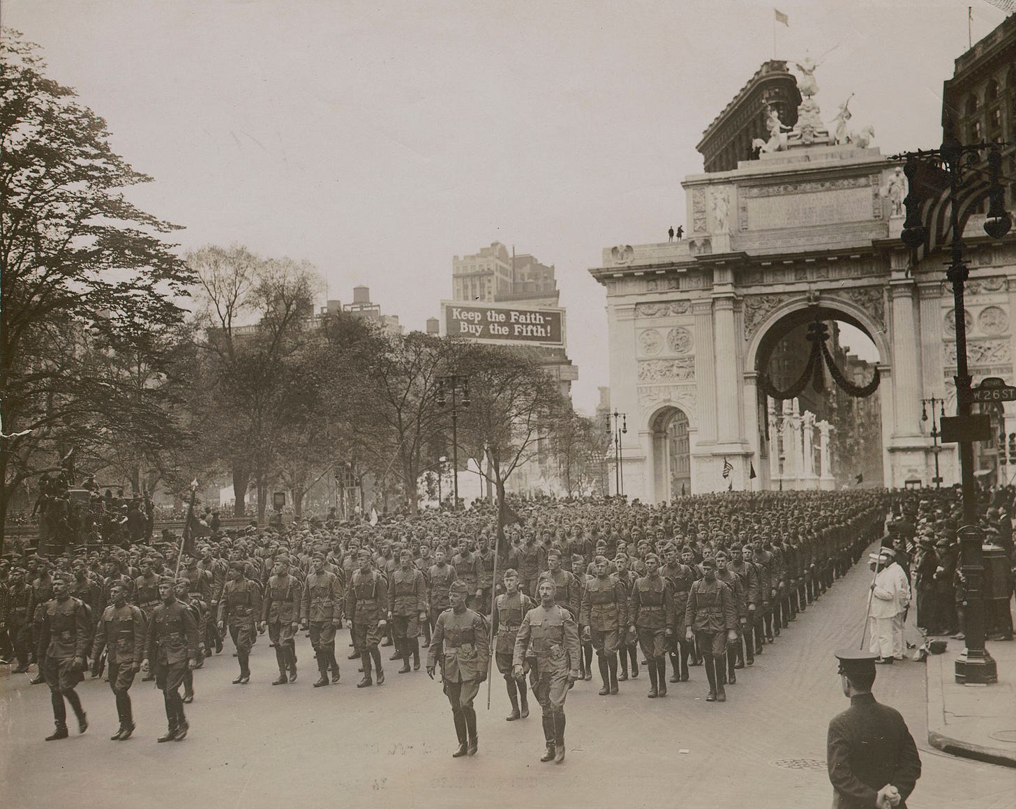 Parade of the 77th Division, 1919. General view of the parade showing a company passing through the Victory Arch at Madison Square in mass formation, the same formation used by the Division in their review before General Pershing. Underwood &amp; Un…