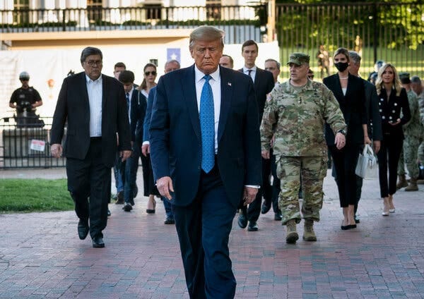A person in a suit walking down a brick walkway with people in the background

AI-generated content may be incorrect.
