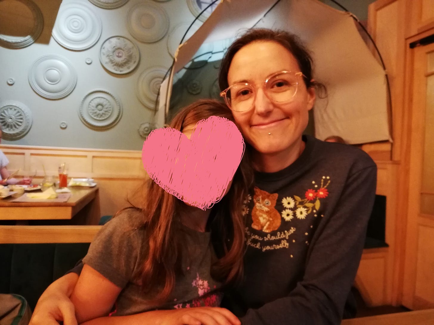 The picture shows the author two weeks after her first infection with Covid 19. She is sitting next to her niece, whose face is not shown. The picture shows the author two weeks after her first infection with Covid 19. She is sitting next to her niece, whose face is not shown.