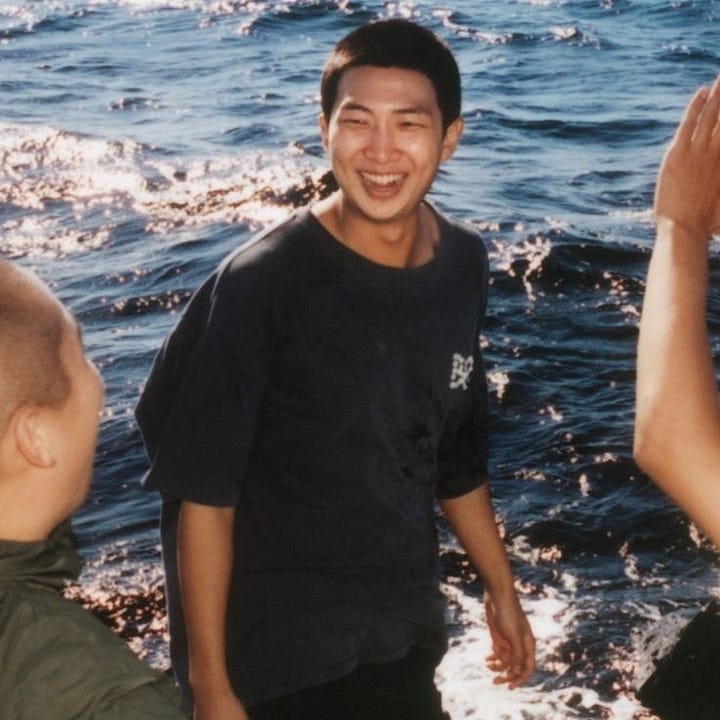 RM in denim, winking at camera. RM in a t-shirt, smiling on the beach.