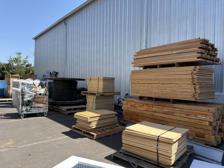The BRING Construction Materials Recovery Program has been working with the University of Oregon to recycle materials from Hamilton Hall. Deconstructed beds, desks, and tables are piled up in BRING's reclaimed materials store, pictured on July 29, 2025.