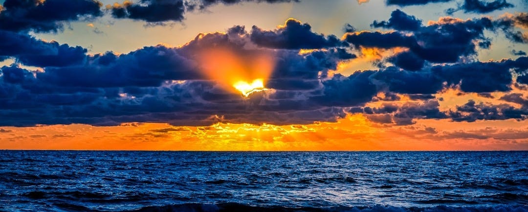 body of water during sunset