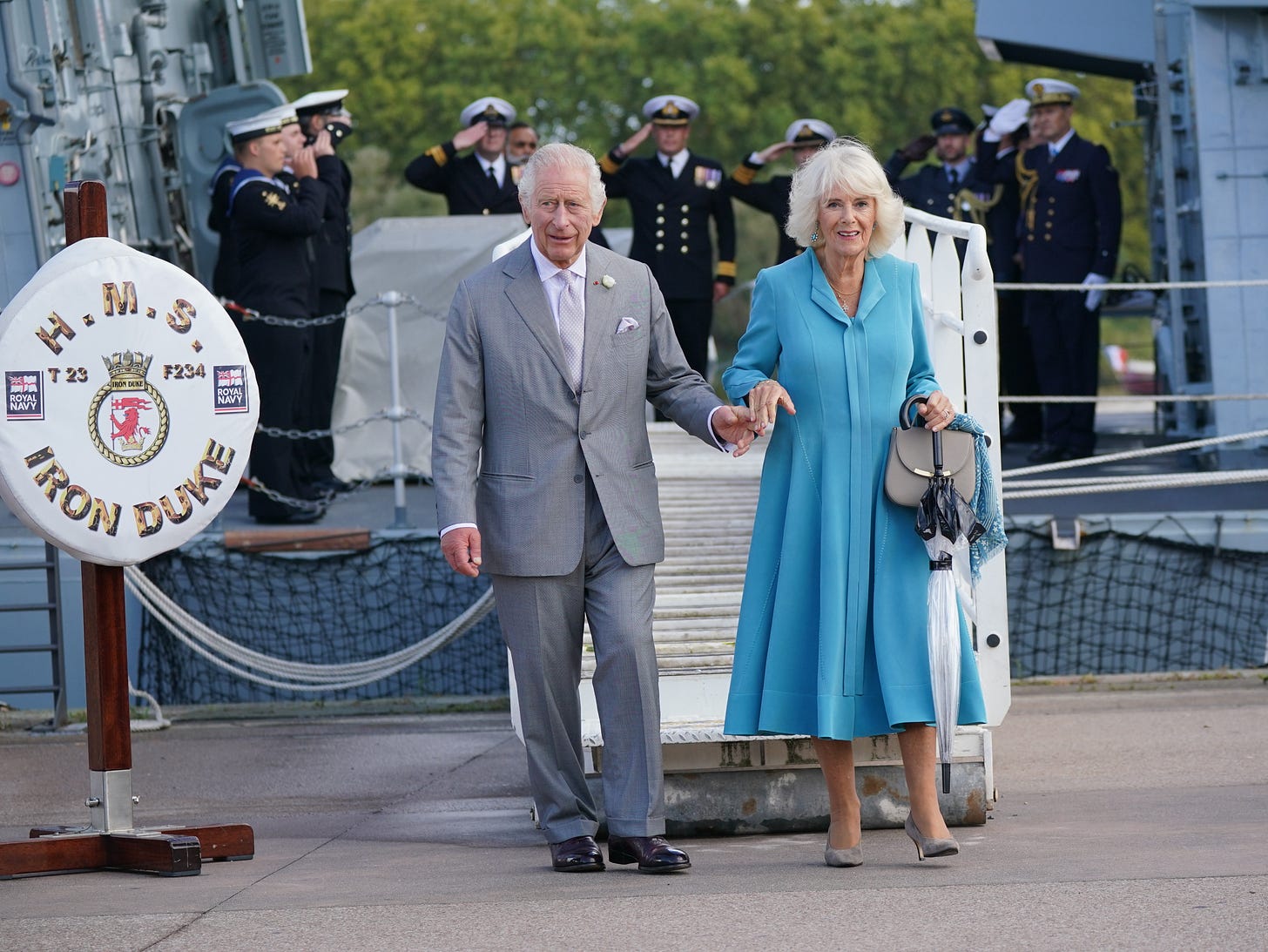 King Charles and Queen Camilla disembark from HMS Iron Duke in France. King Charles and Queen Camilla disembark from HMS Iron Duke in France.