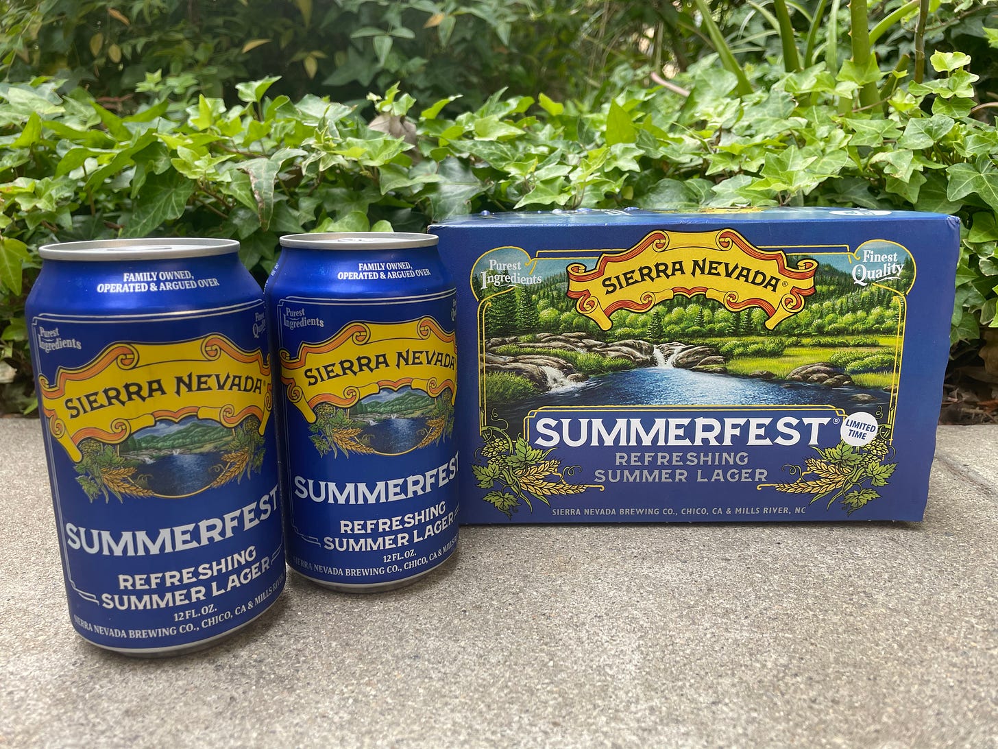 Two Sierra Nevada "Summerfest" Lager cans next to the blue cardboard sixpack of Summerfest