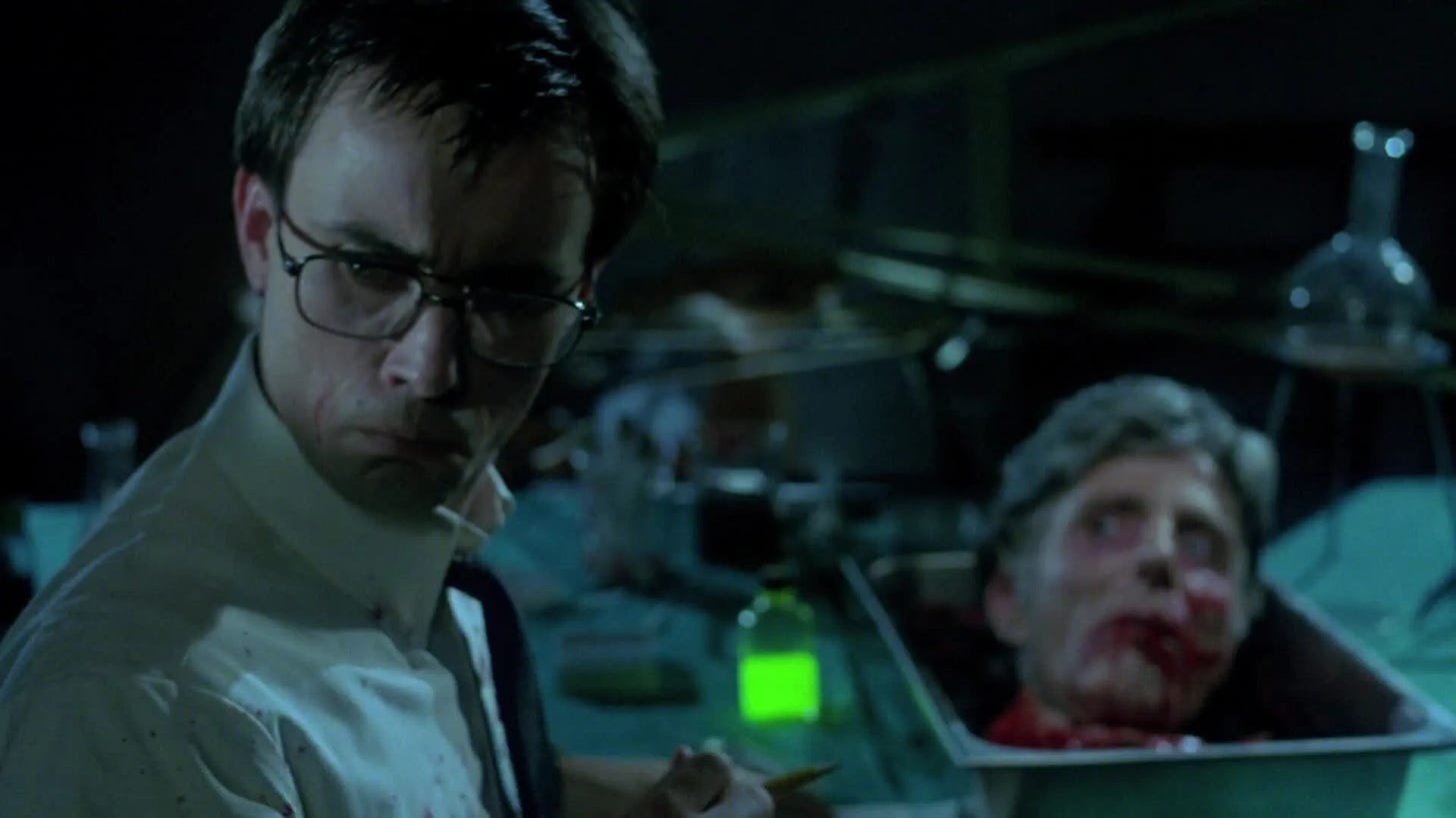 geeky scientist type in foreground looking off to side and holding syringe with neon green liquid; over to the other side is a head in a bucket, looking disturbed but sly geeky scientist type in foreground looking off to side and holding syringe with neon green liquid; over to the other side is a head in a bucket, looking disturbed but sly