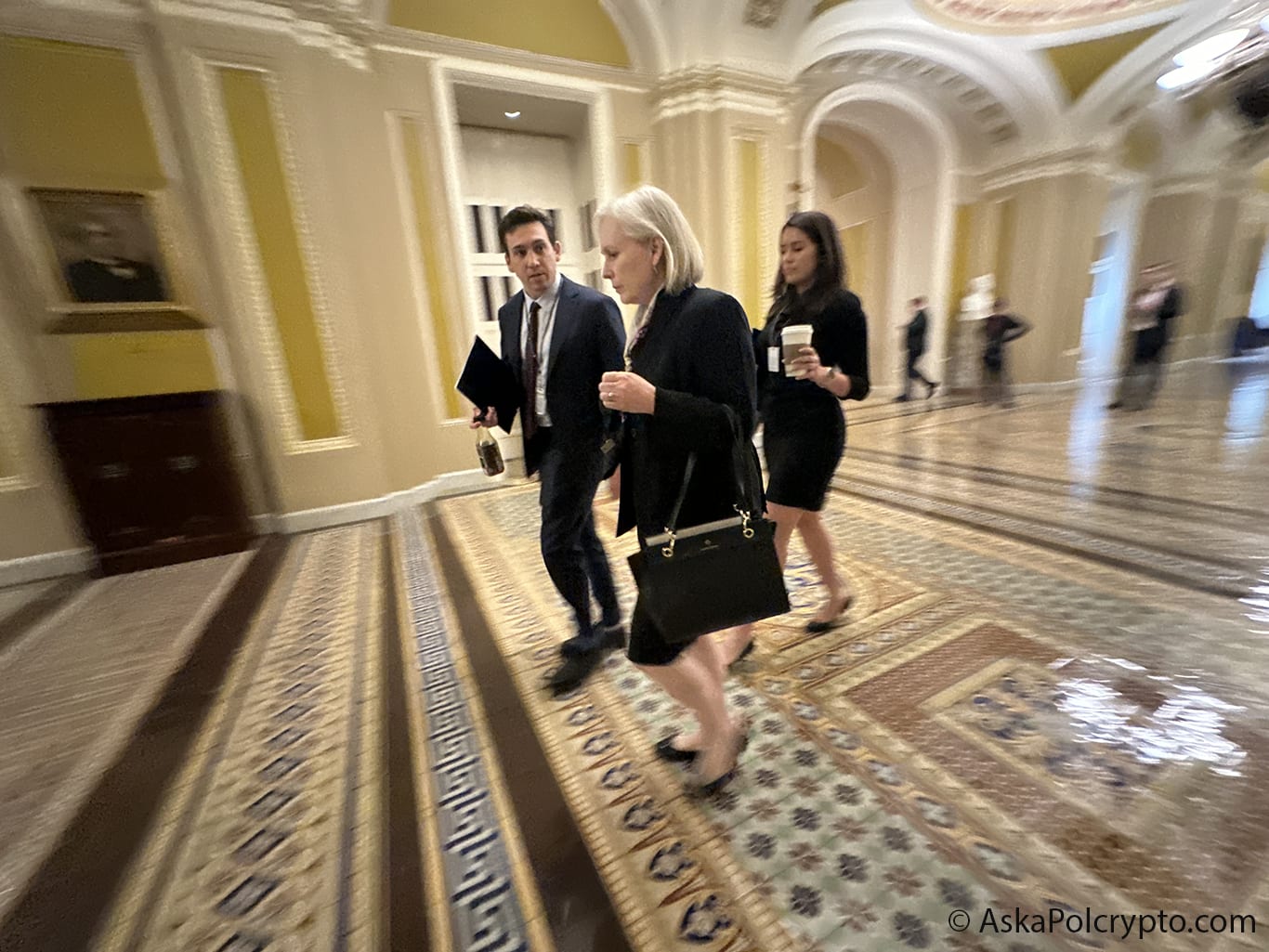 Senator and aides walk on marble floors of US Capitol. Photo: Matt Laslo © Ask a Pol Crypto