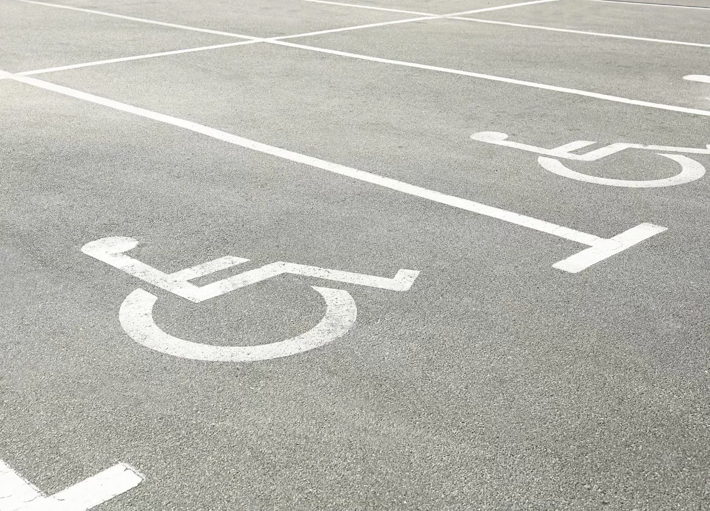 Black and white photo of accessible parking spaces marked with wheelchair symbols
