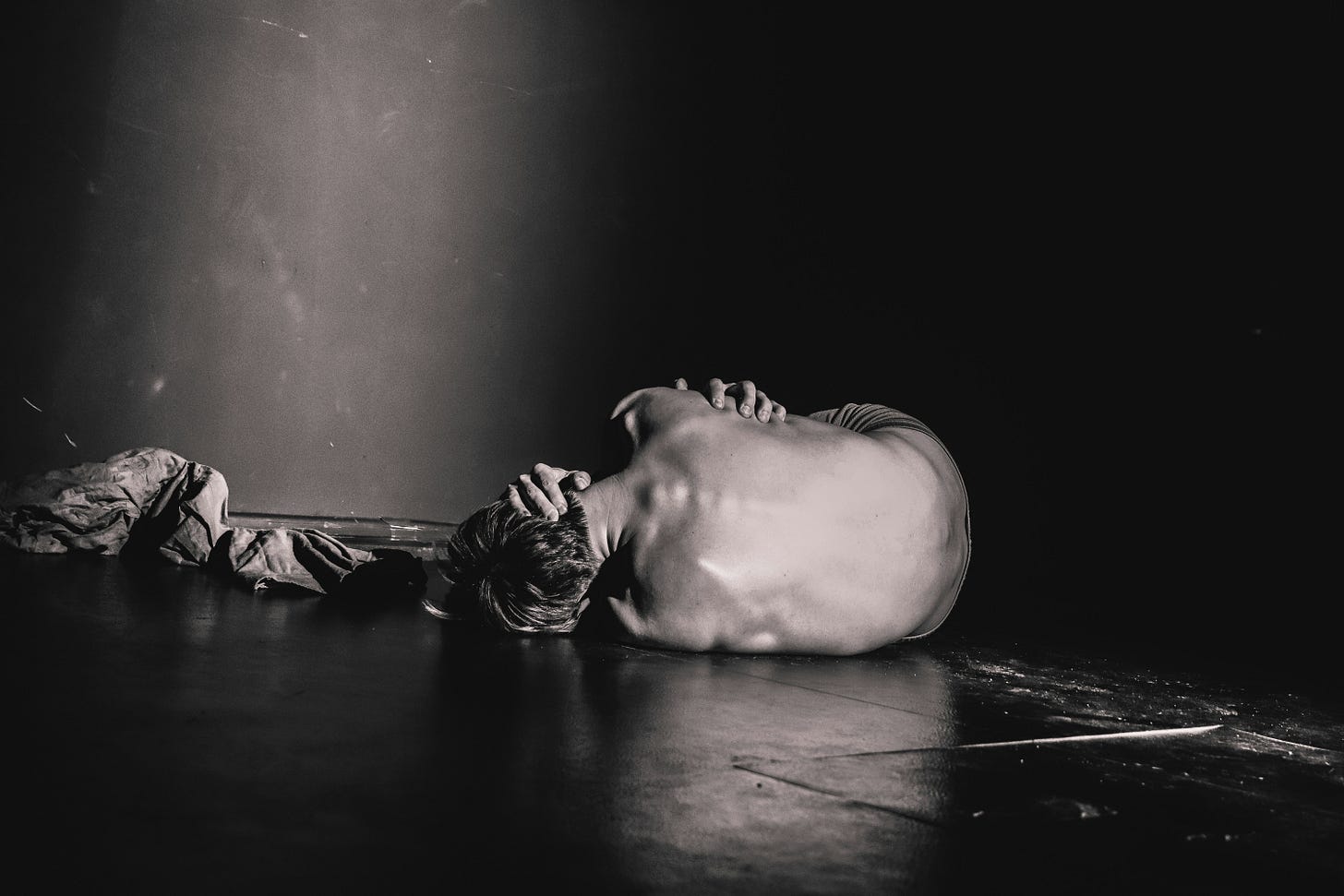 man on floor in deep pain