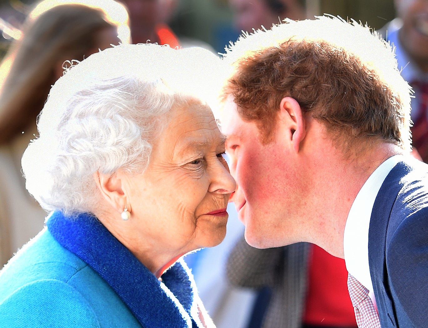 Prince Harry whispering something to the Queen Elizabeth II