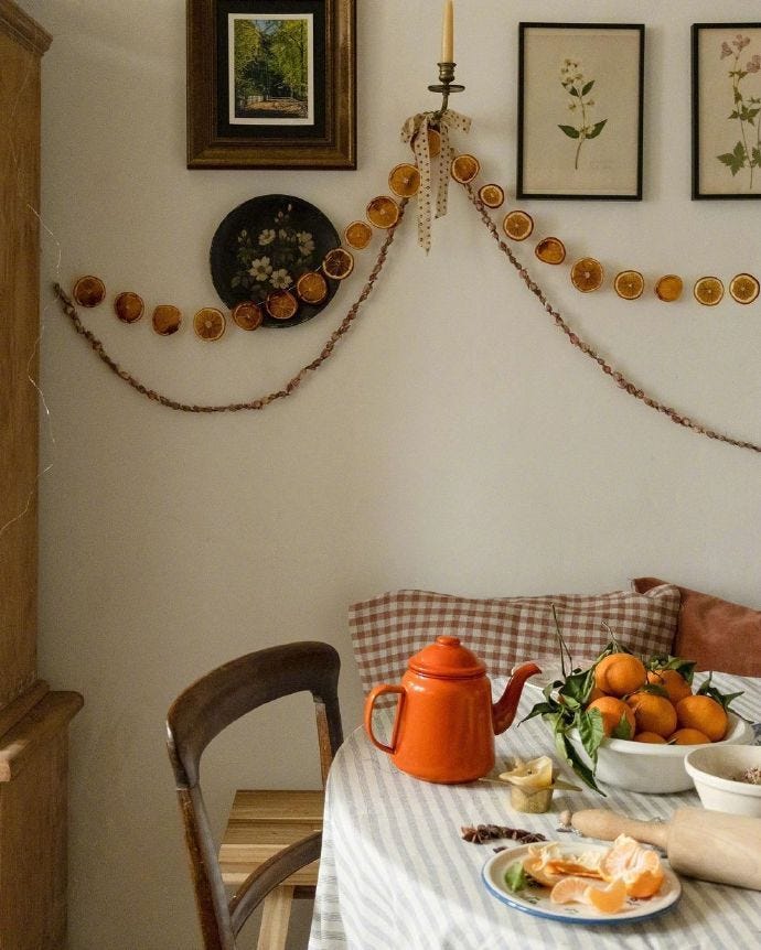 This may contain: a dining room table with plates, cups and bowls on it next to pictures hanging on the wall