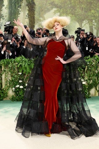 Image may contain Gwendoline Christie Adult Person Camera Electronics Fashion Clothing Hat Accessories and Glasses