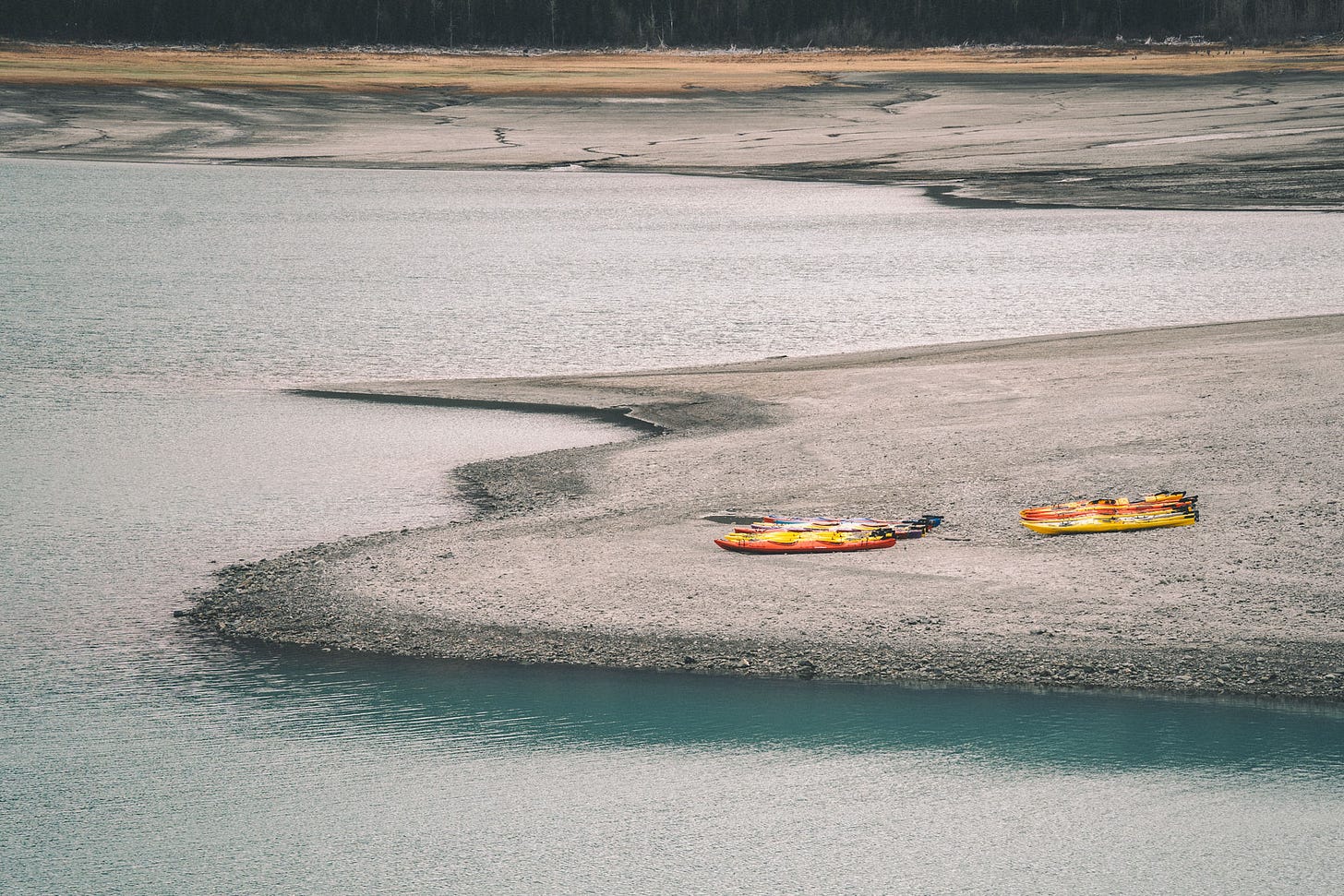 Sea kayaks on the shore of Eklutna Lake.
