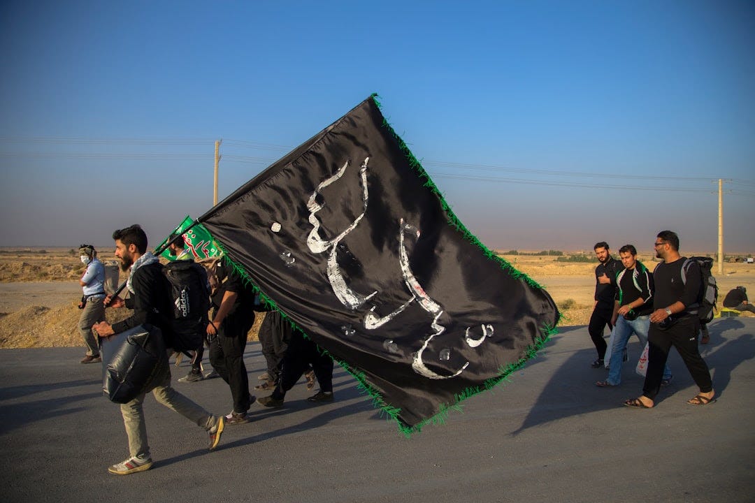 man holding flag while walking with other men