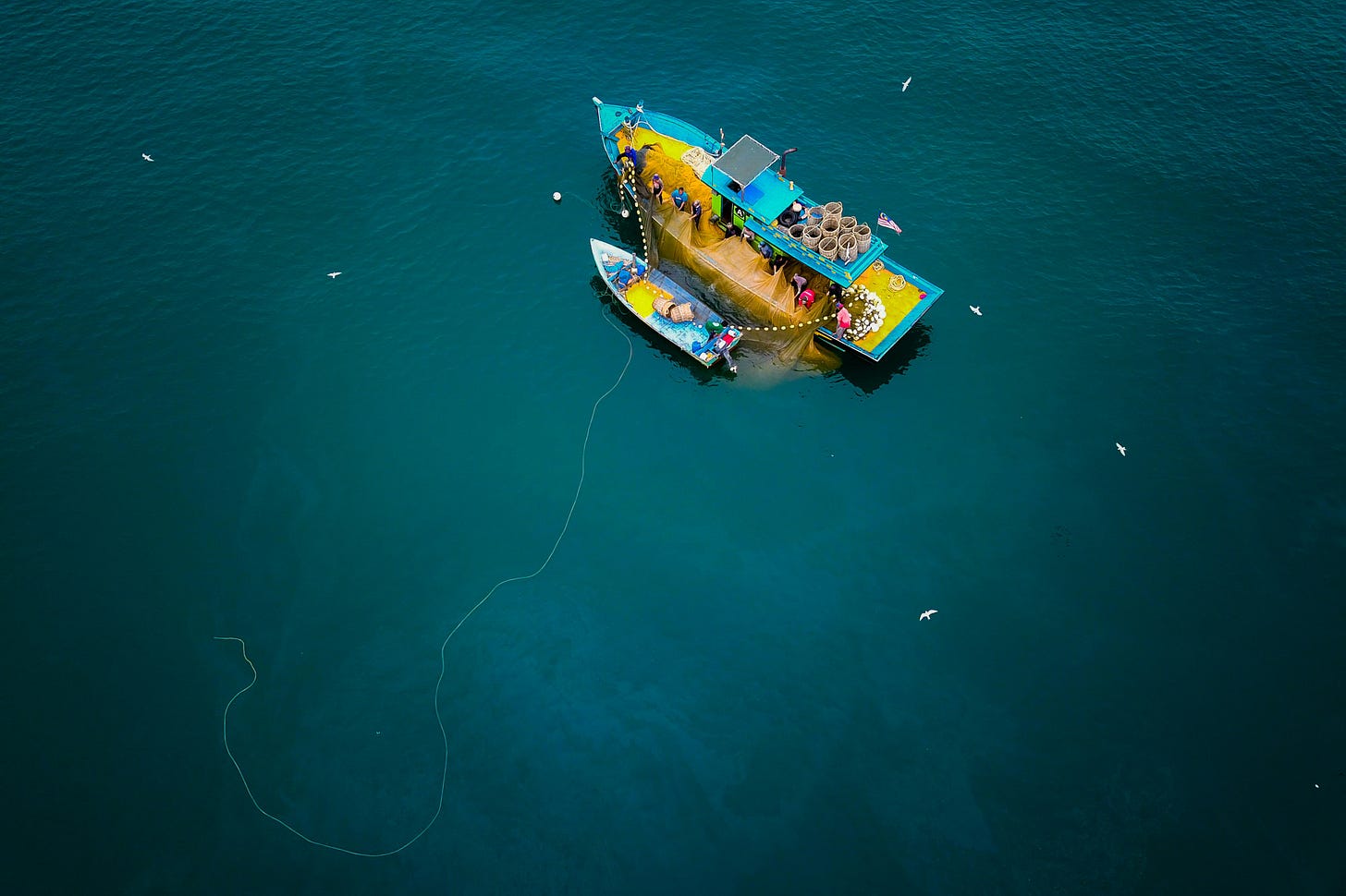Commercial fishing boats are fishing in the sea. Commercial fishing boats are fishing in the sea.