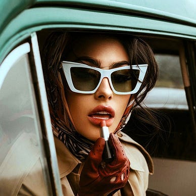 Woman reapplying lipstick, wearing sunglasses
