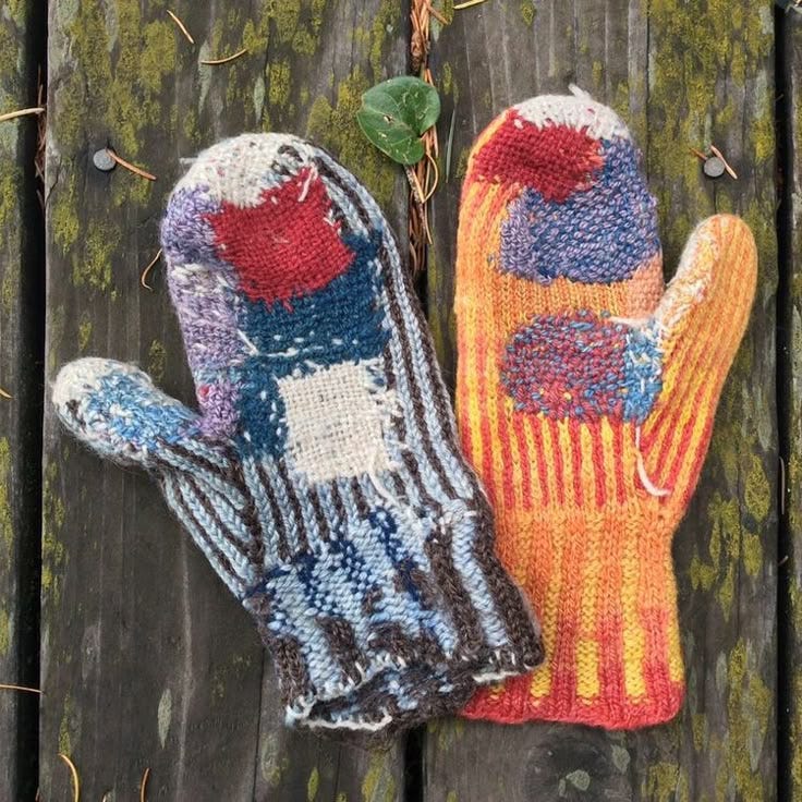 This may contain: two mittens sitting on top of a wooden table