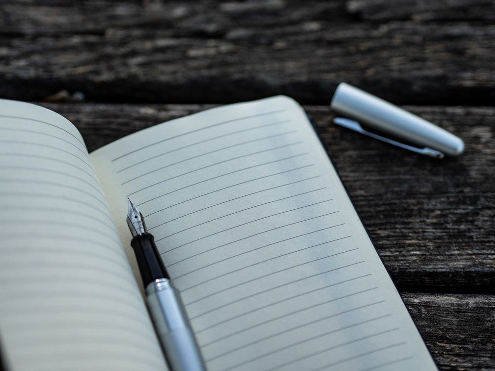 gray and black fountain pen and book gray and black fountain pen and book