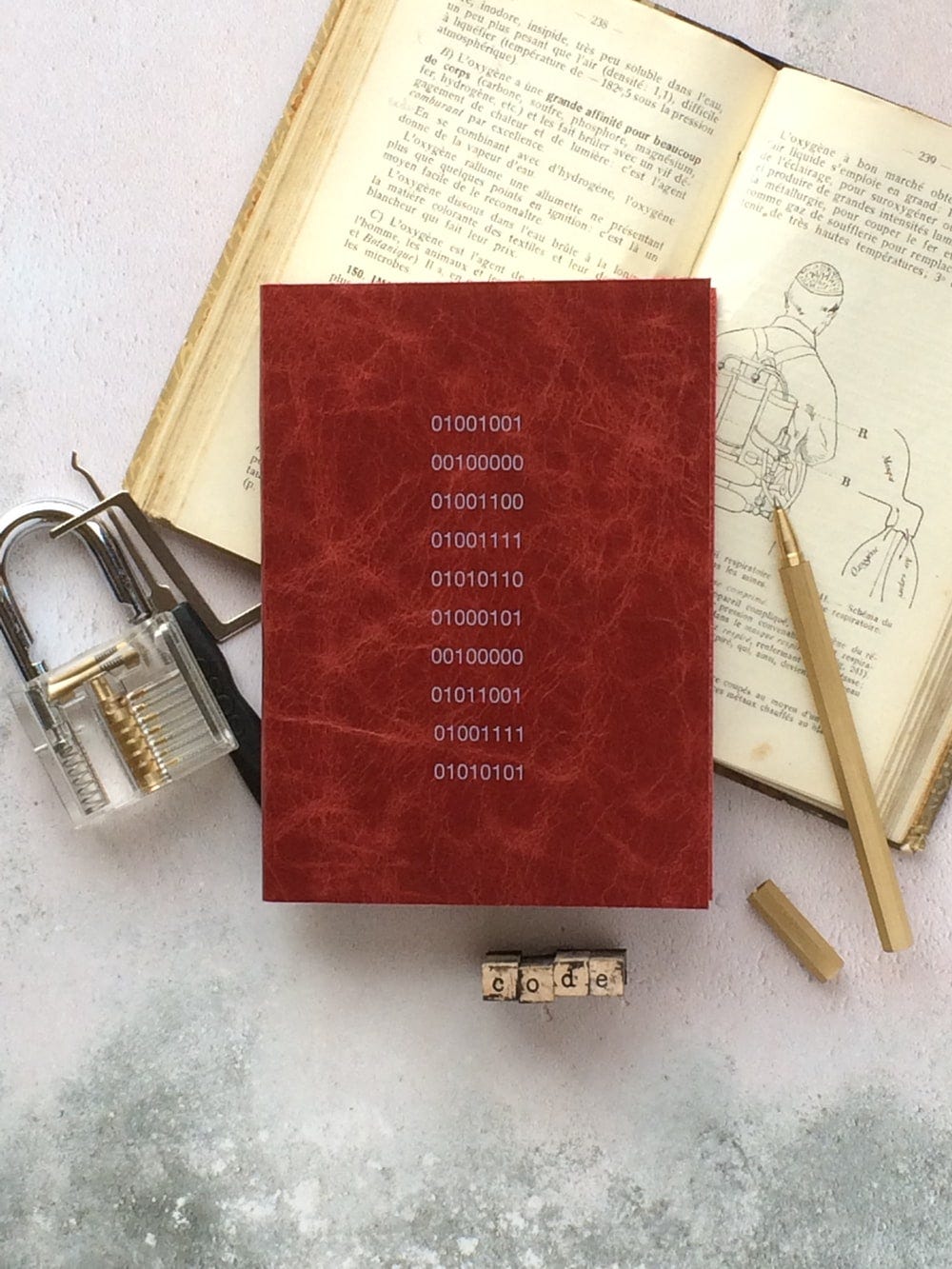 stainless steel padlock beside book and pen stainless steel padlock beside book and pen