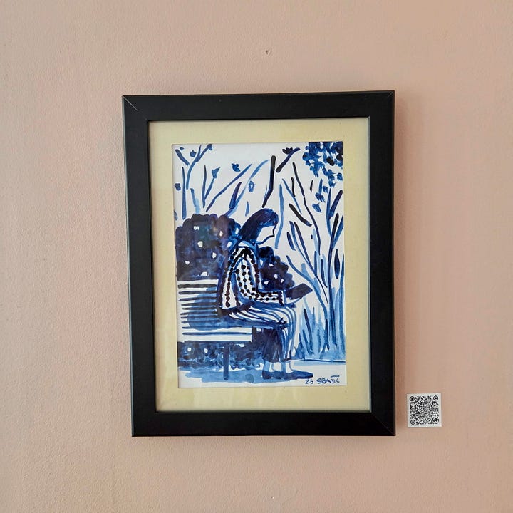 Framed art pieces in blue ink for sale. On a wall